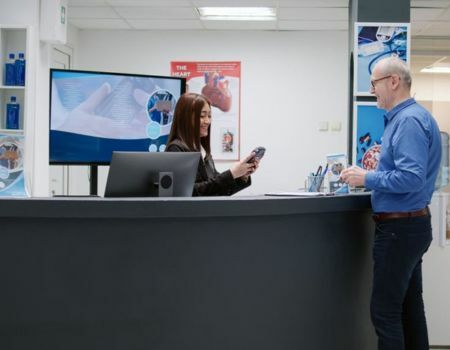 staff is catering the patient at reception desk